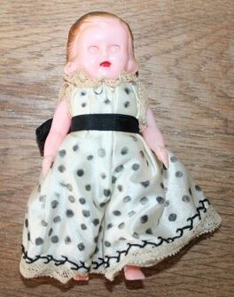 Old vintage brocante doll with satin polka dot dress