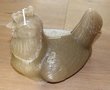 Decorative large olive brown candle lying chicken